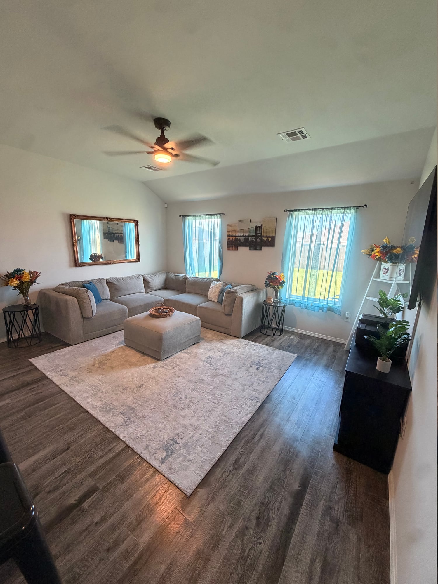 Sunlit living room with a large sectional sofa